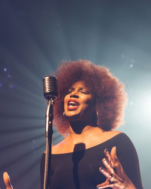 Coach singing soul at a vintage microphone